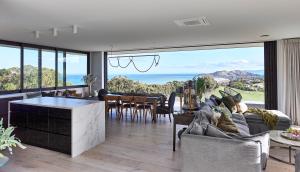 a living room with a view of the ocean at Ocean + Country - Wainui Beach in Gisborne