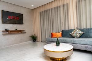 a living room with a couch and a table at Maarif elite suites in Casablanca
