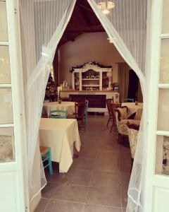 a dining room with tables and chairs and a tent at Corte Boero Bed&Breakfast in Capoterra