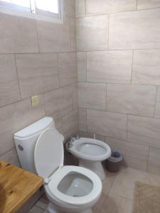 a bathroom with a toilet and a sink at La Catalina 2 in San Antonio de Areco