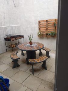 a table and two chairs with a potted plant on it at La Catalina 2 in San Antonio de Areco +4 photos