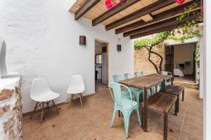 a dining room with a wooden table and chairs at 8 Guests Large Villa near Bossa Beaches & Airport in Sant Josep de Sa Talaia
