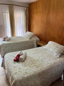 a hotel room with two beds with towels on them at Hare o Koro (Ex Vai Kapua) in Hanga Roa