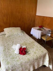 a bedroom with a bed with towels and a table at Hare o Koro (Ex Vai Kapua) in Hanga Roa