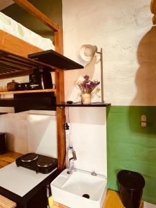 a bathroom with a sink and a bunk bed at Yê Tiny Houses in Palmeiras