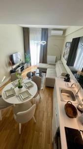 a living room with a table and a couch at Diamond of Skopje Luxury apartment 19th floor in Skopje