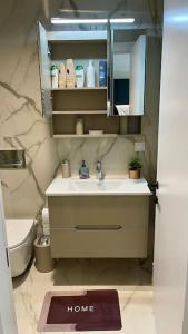 a bathroom with a sink and a mirror at Diamond of Skopje Luxury apartment 19th floor in Skopje +55 photos