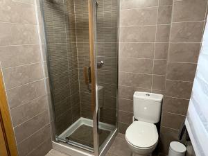 a bathroom with a shower with a toilet and a sink at Cardenas Home Diamante in Santa Fe