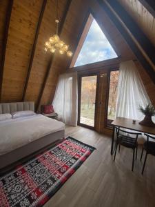 a bedroom with a bed and a table and window at Agora Farmhouse in Koman +165 photos