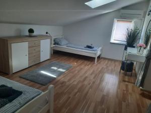 a living room with a bed and a window at Martina Apartments in Funtana