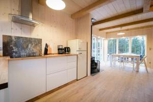 a kitchen with a white refrigerator and a table at Hotel Kozi Gród in Pomlewo