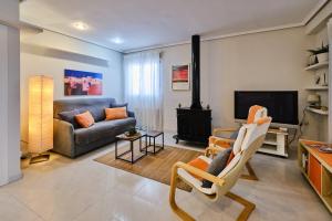 a living room with a couch and a fireplace at Penthouse Inlakesh in Valencia