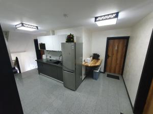 a kitchen with a refrigerator and a table in it at Willa Bafijówka in Groń