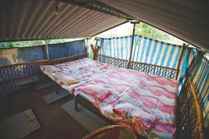 a bed in a tent in a room at Gokul farm house in Sasan Gir