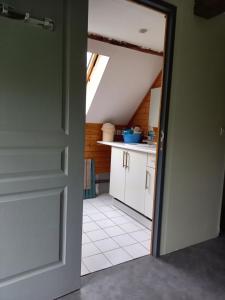 an open door to a kitchen in a attic at gite de la Chevrie in La Baconnière