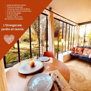 a magazine advertisement for a house with a table with an orange on it at *L'Orangeraie* Maison avec jardin, tennis, parking in Nîmes