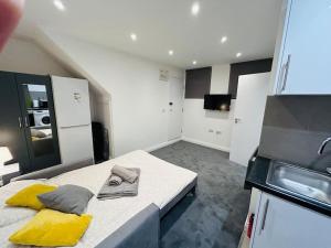 a kitchen with a large bed in a room at Cosy Studio near Emirates Stadium in London