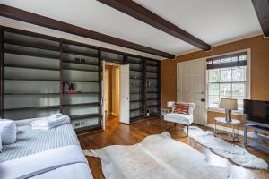 a bedroom with a bed and a tv and shelves at LUX Entire home in Bethesda RARE in Bethesda