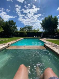 a person laying in the water in a swimming pool at Maridaje Hosting in Ciudad Lujan de Cuyo