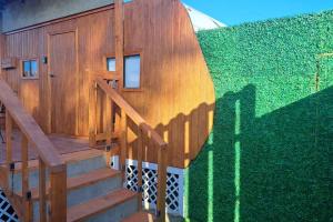 a staircase leading to a house with a green wall at Sunset Trailer Park RV # 2 in El Suazal
