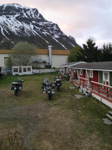 a group of motorcycles parked next to a building with a mountain at Best no1 in Manndalen