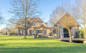 a brick house with an umbrella in the yard at Lovely warm Country home in Breukeleveen