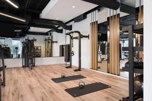 a gym with treadmills and elliptical machines at Loews Nashville Hotel at Vanderbilt Plaza in Nashville