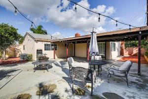 a patio with a table and chairs and an umbrella at Buena Park Home with Patio about 9 Mi to Disneyland! in Buena Park