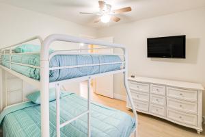 a bedroom with two bunk beds and a flat screen tv at Buena Park Home with Patio about 9 Mi to Disneyland! in Buena Park