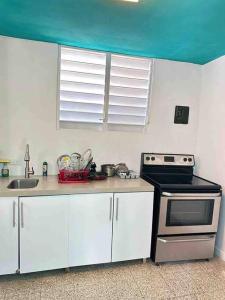 a kitchen with a stove and a sink at 6 bedsroom 3 baths beach shopping Carolina Puerto Rico by Rentalspr in Carolina