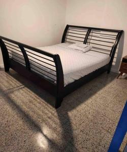 a bed with a black frame in a room at 6 bedsroom 3 baths beach shopping Carolina Puerto Rico by Rentalspr in Carolina