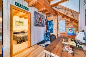 a room with a bed and a desk in a cabin at Riverfront A-Frame Cabin in Troy with Pool and Dock! in Troy