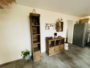 a kitchen with a refrigerator and a wooden shelf at Duplex Sole Mio in Bazet