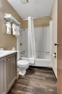 a bathroom with a toilet and a sink and a shower at Bison Plains Lodge in Moorhead