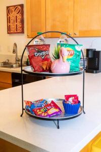 a shelf with chips and other snacks on a kitchen counter at Colorful Home 3Bd 2Ba, Sleeps8, 1block to Univ., Pac-man, BBQ, FirePit in Redlands