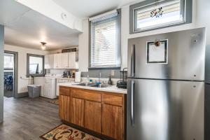 a kitchen with a stainless steel refrigerator and a sink at Close to Casinos and Trails Historic Victor Cottage in Victor