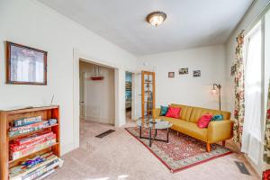 a living room with a couch and a table at Close to Casinos and Trails Historic Victor Cottage in Victor