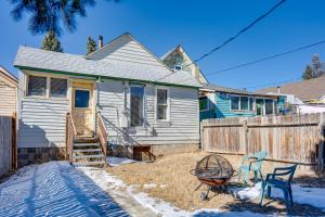 a white house with two chairs and a fence at Close to Casinos and Trails Historic Victor Cottage in Victor