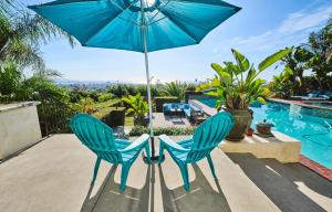 a table and two chairs with an umbrella on a patio at 360 Degree Ocean & City Views With Pool, Spa, Close to the Beach! Pets OK in San Diego