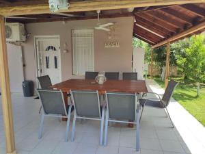 a wooden table and chairs on a patio at ofrynio kavalas Martin House in Karianí