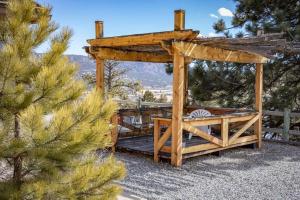 a wooden gazebo in a yard with a pine tree at Private 313 Acre retreat/lakes/direct forest entry in Buena Vista
