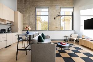 a living room with a couch and a table at Switch House Hotel in Philadelphia