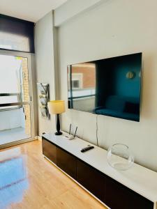 a living room with a large mirror on the wall at Apartamento Turístico Pizarro in Mérida