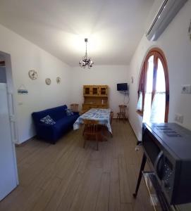 a living room with a blue couch and a table at La Calla Bianca in Torre Dei Corsari