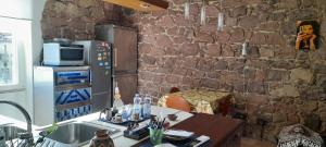 Una cocina con fregadero y una pared de piedra. en La casa di Grace IUN P2482, en Nuoro 13 fotos más