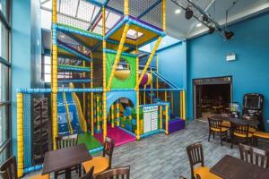 a restaurant with a play room with a playground at 519 Family Caravan at Golden Gate Holiday Centre, Sleeps 6 in Abergele
