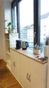 a kitchen with a counter with a large window at Apartment Grindelallee Hamburg in Hamburg