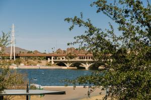 a bridge over a body of water with a bridge at Sonder at Mill Ave in Tempe