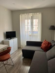 a living room with a couch and a television at Fantastic 1 Bedroom Apartment at Roma Avenue - 1B in Lisbon