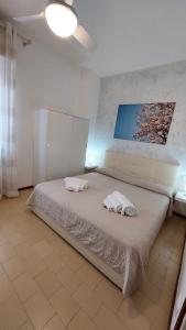a bedroom with a bed with two towels on it at Verbena Holiday Apartment in Lazise